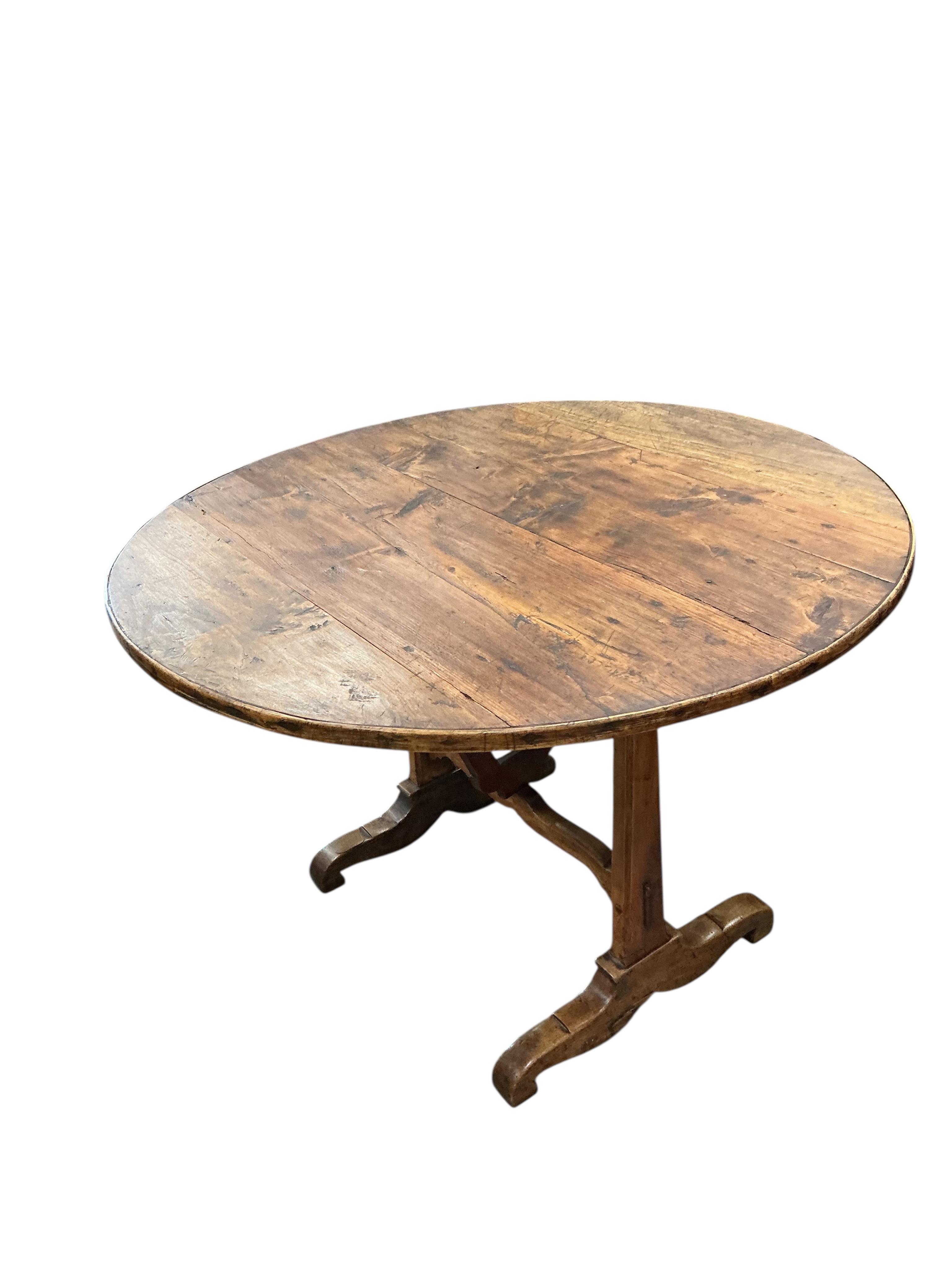 A 19th century French fruitwood wine tasting table, diameter 100cm, height 67cm